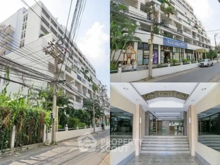 Modern apartment building exterior with lush greenery and spacious entrance.
