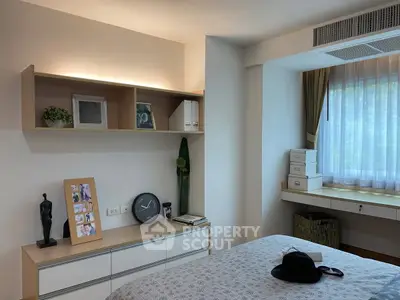 Cozy bedroom with modern decor, featuring a stylish shelf, elegant window, and comfortable bed.