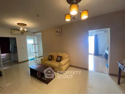 Spacious living room with modern lighting and cozy seating area