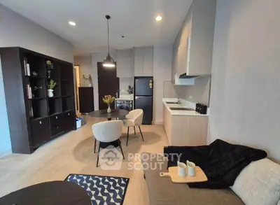 Modern open-layout living room with stylish kitchen and cozy seating area