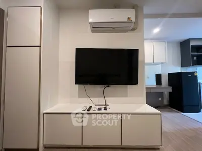 Modern living room with sleek TV setup and air conditioning unit