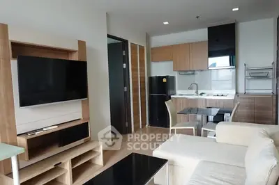 Modern living room with open kitchen layout and stylish furniture in a contemporary apartment.