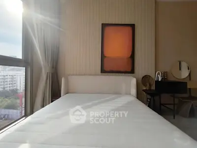 Modern bedroom with large window and stylish decor, featuring a comfortable bed and elegant furnishings.
