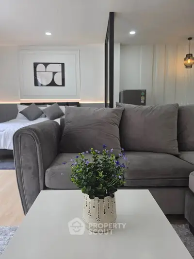 Modern open-plan living room with stylish decor and cozy seating area