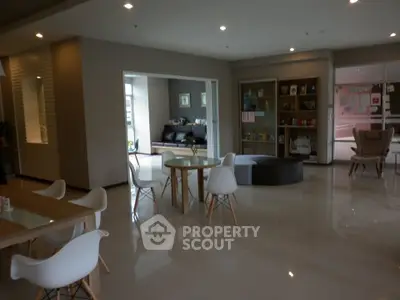 Spacious modern living area with stylish furniture and open layout, perfect for relaxation and social gatherings.