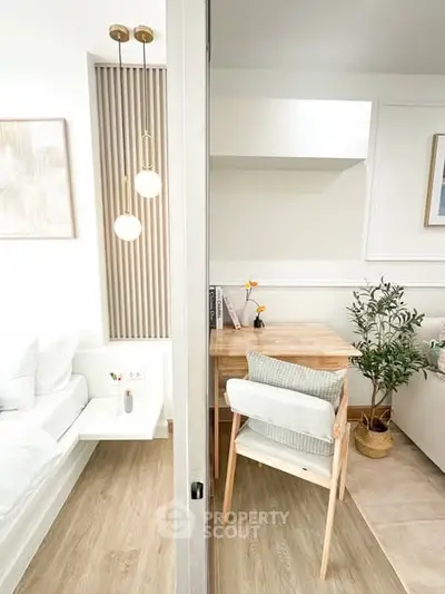 Modern living room with stylish decor and wooden furniture, featuring a cozy dining area and elegant lighting.