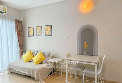 Charming living room with cozy sofa, dining table, and bright decor