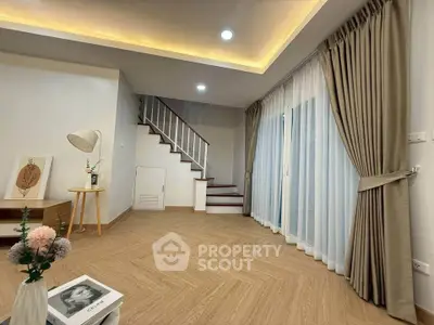 Stylish living room with elegant staircase and modern decor