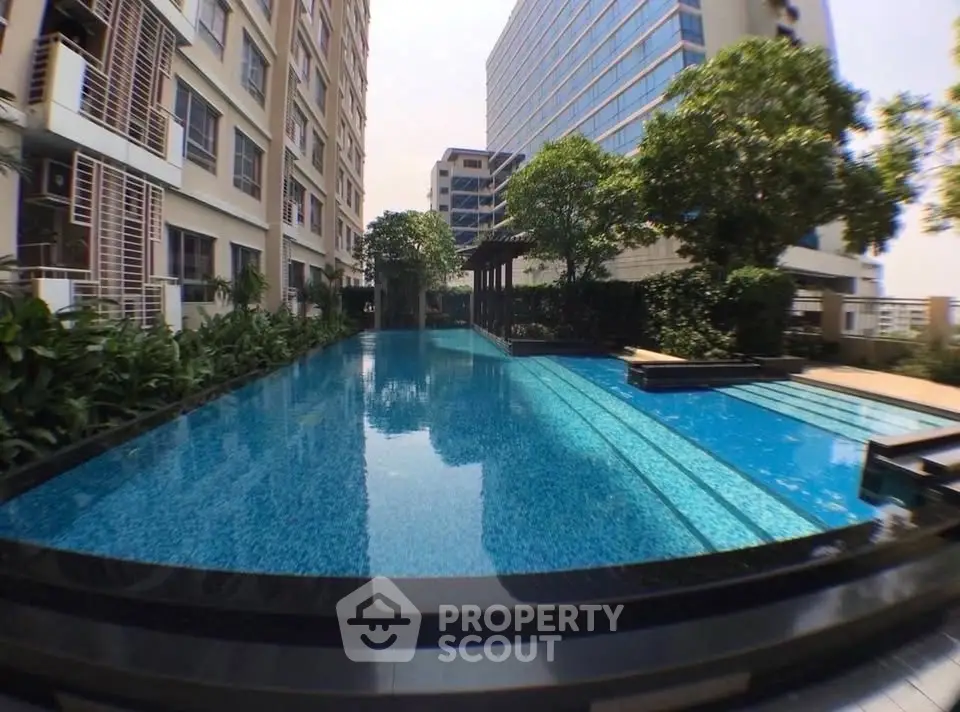 Luxurious condominium with stunning outdoor pool and lush greenery