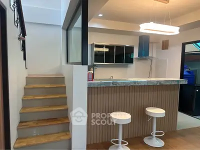 Modern kitchen with breakfast bar and stylish lighting in a contemporary home