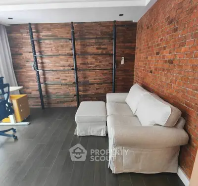 Stylish living room with exposed brick wall and modern furniture