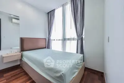 Modern bedroom with large window and sleek design in a stylish apartment.