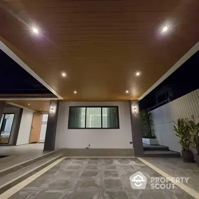 Modern exterior patio with stylish lighting and wooden ceiling design