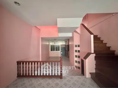 Spacious interior with unique staircase and pink walls, perfect for creative home design.