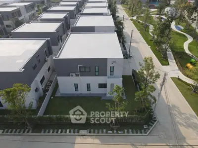 Modern residential complex with contemporary architecture and lush green surroundings.