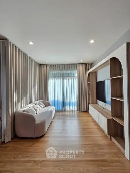 Modern living room with elegant curtains and sleek wooden flooring