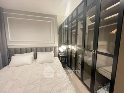 Luxurious bedroom with elegant mirrored wardrobe and plush bedding