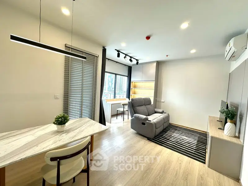 Modern living room with sleek furniture and city view, perfect for urban living.