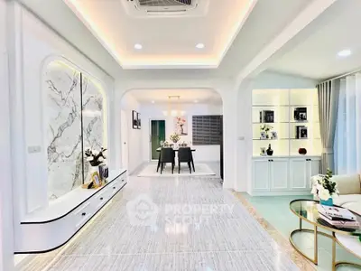 Luxurious open-plan living room with elegant marble accents and modern lighting