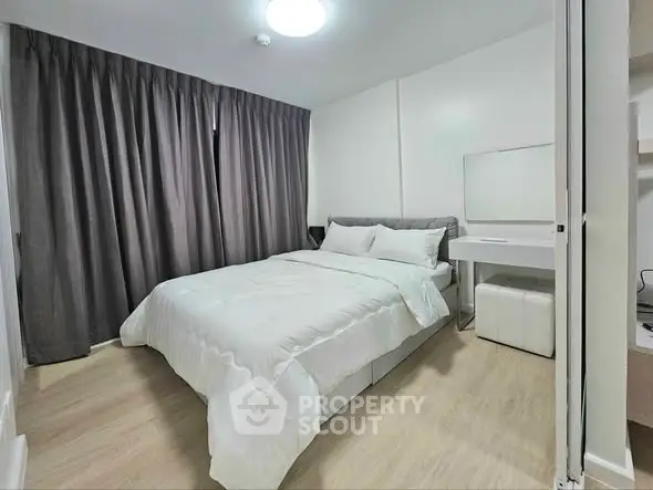 Modern bedroom with cozy bedding and elegant decor in a stylish apartment.