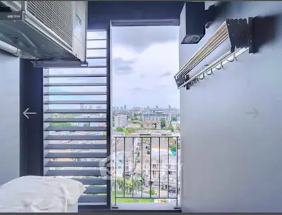 Stunning city view from a modern balcony with sleek design and ample natural light.