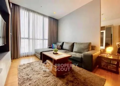 Modern living room with cozy sofa and large window in stylish apartment.