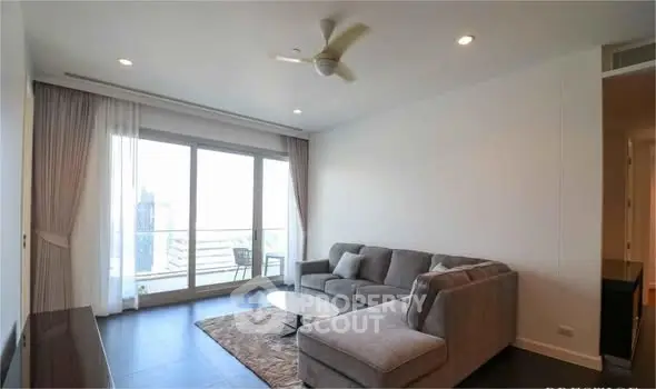 Spacious living room with large windows and modern furniture