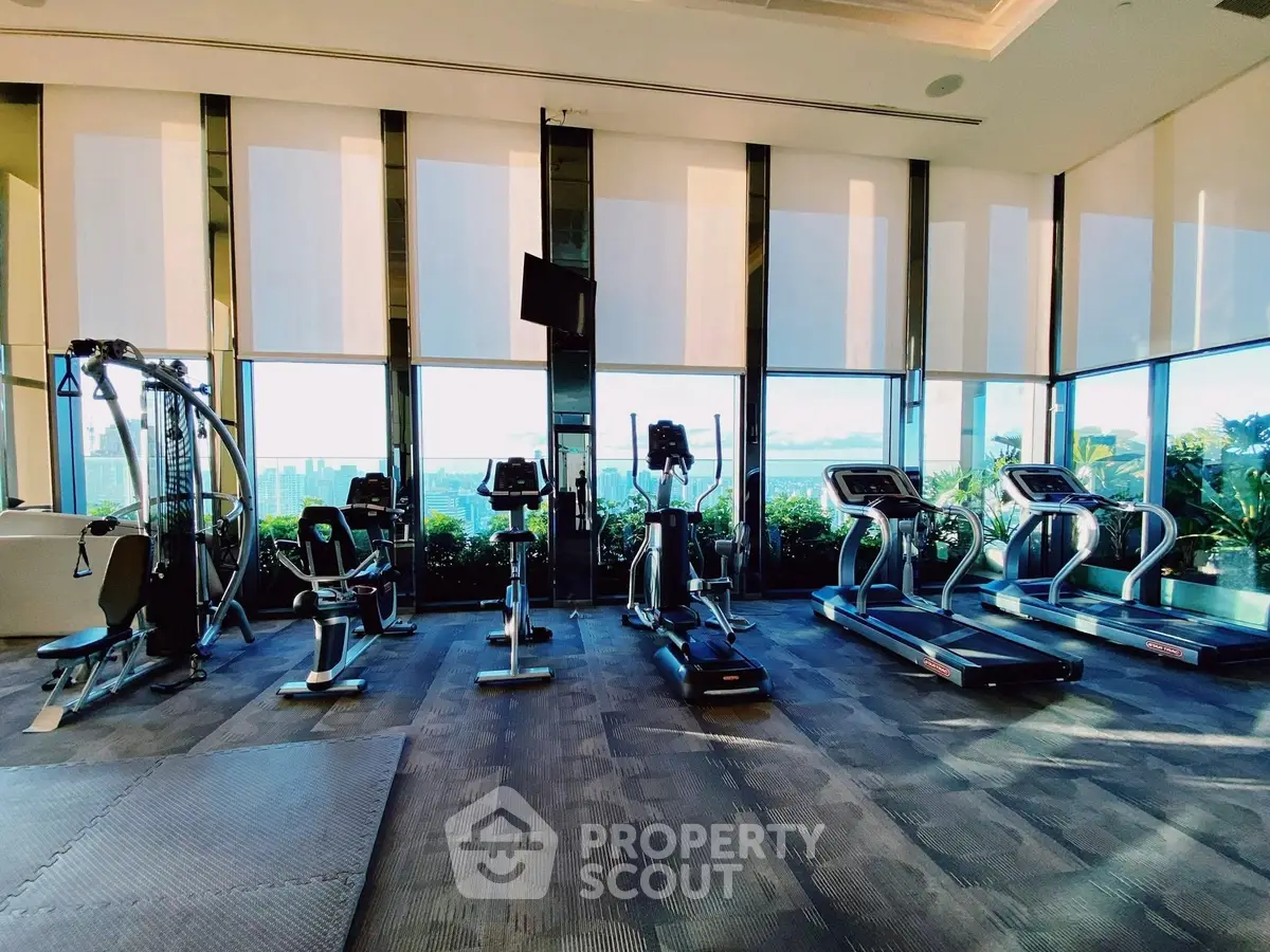 Luxurious gym with modern equipment and panoramic city views, perfect for fitness enthusiasts seeking a premium workout space.