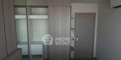 Modern minimalist bedroom with built-in wardrobe and air conditioning