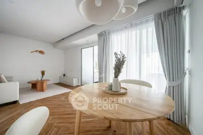 Modern living room with wooden flooring and elegant dining area