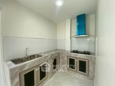 Modern kitchen with sleek cabinetry and gas stove