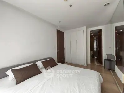 Modern bedroom with sleek design and ample storage in a contemporary apartment.