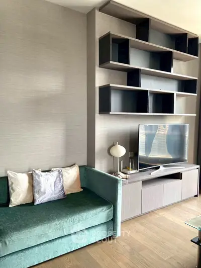 Modern living room with stylish shelving and cozy green sofa