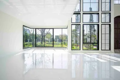 Spacious modern living room with large windows and garden view