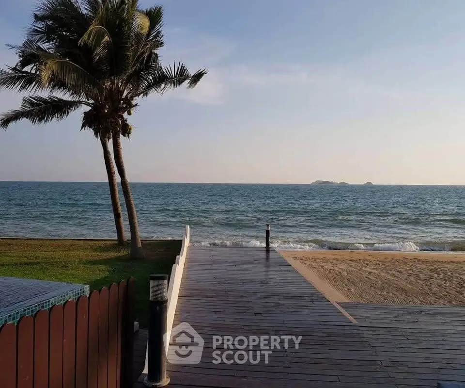 Stunning beachfront property with direct ocean access and palm trees, perfect for serene coastal living.