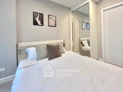 Modern bedroom with stylish decor and mirrored closet doors