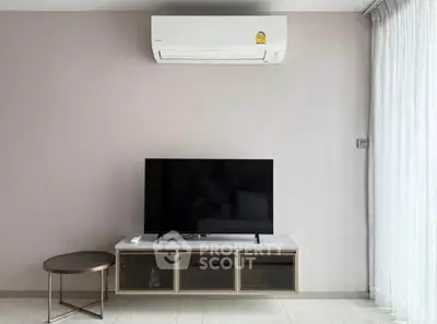 Modern living room with sleek TV setup and air conditioning