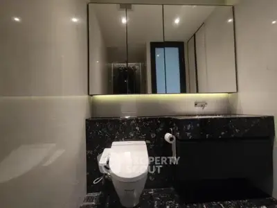Luxurious modern bathroom with sleek black marble and elegant lighting