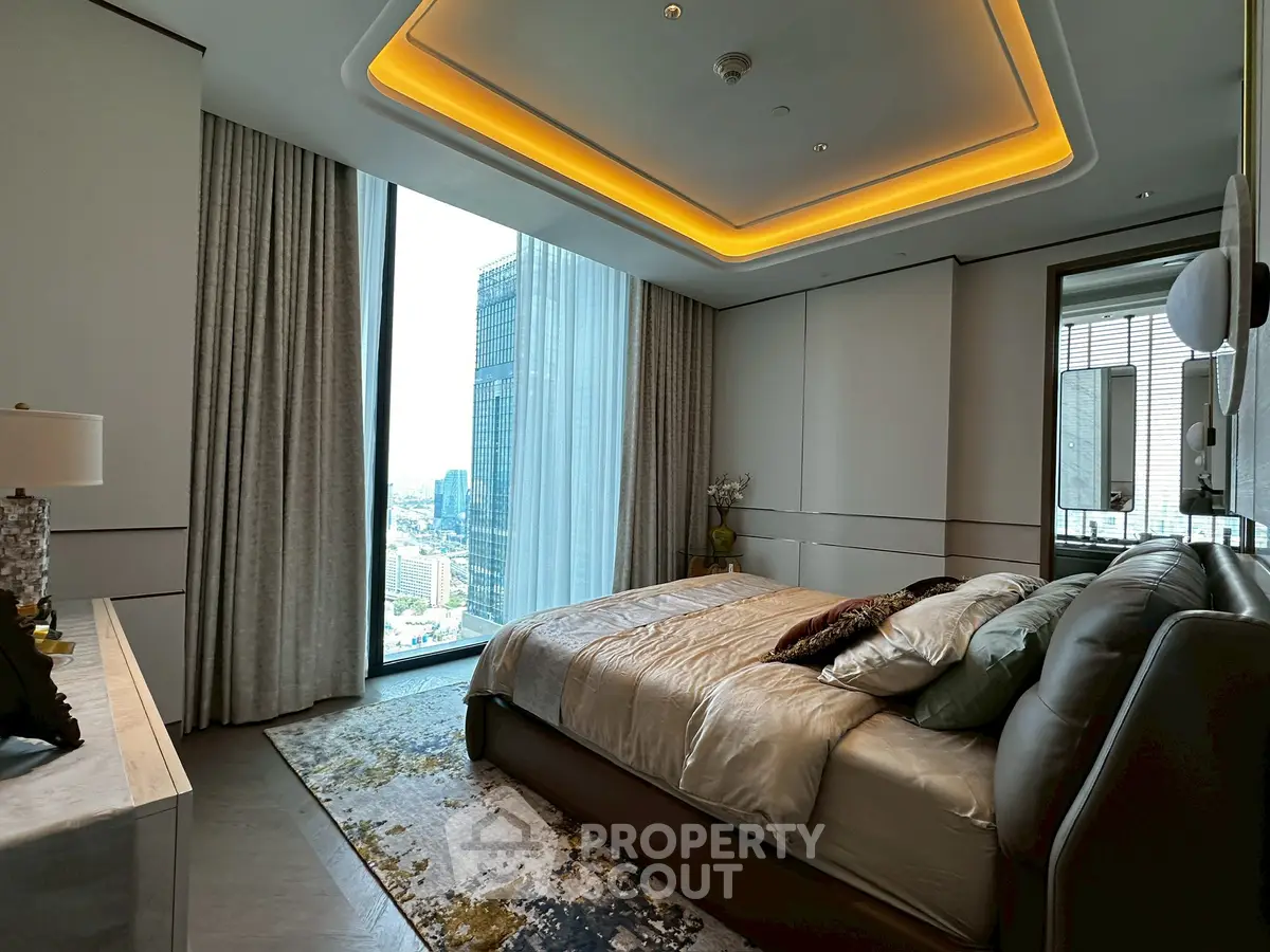 Luxurious bedroom with city view, modern lighting, and elegant decor in high-rise apartment.