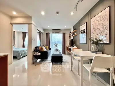 Modern open-plan living room with stylish decor and natural light