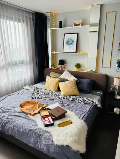 Modern bedroom with stylish decor and large window for natural light