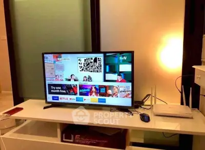 Modern living room with TV and internet setup, showcasing a cozy and tech-friendly environment.