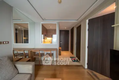 Modern living room with wooden flooring and stylish furniture in a contemporary apartment.