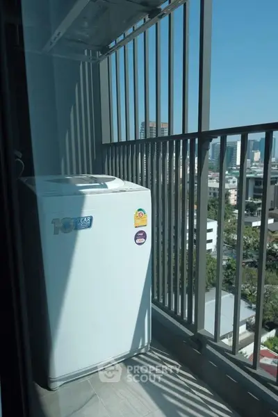 Urban balcony with washing machine and city view, perfect for modern living convenience.