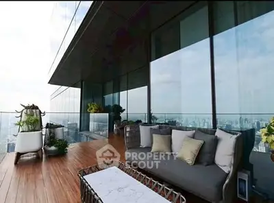 Luxurious high-rise balcony with stunning city view and modern outdoor furniture.