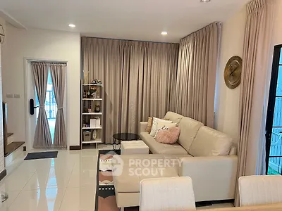 Stylish living room with elegant curtains and modern white sofa in a cozy apartment.