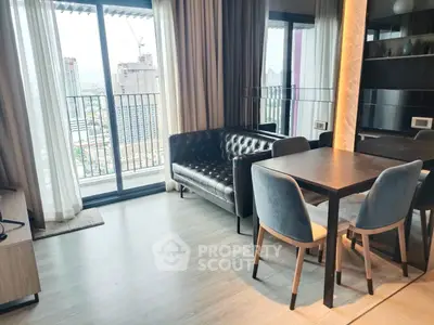Modern living room with city view, featuring sleek furniture and large windows opening to a balcony.