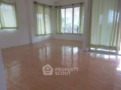 Spacious empty room with large windows and tiled flooring, perfect for customization.