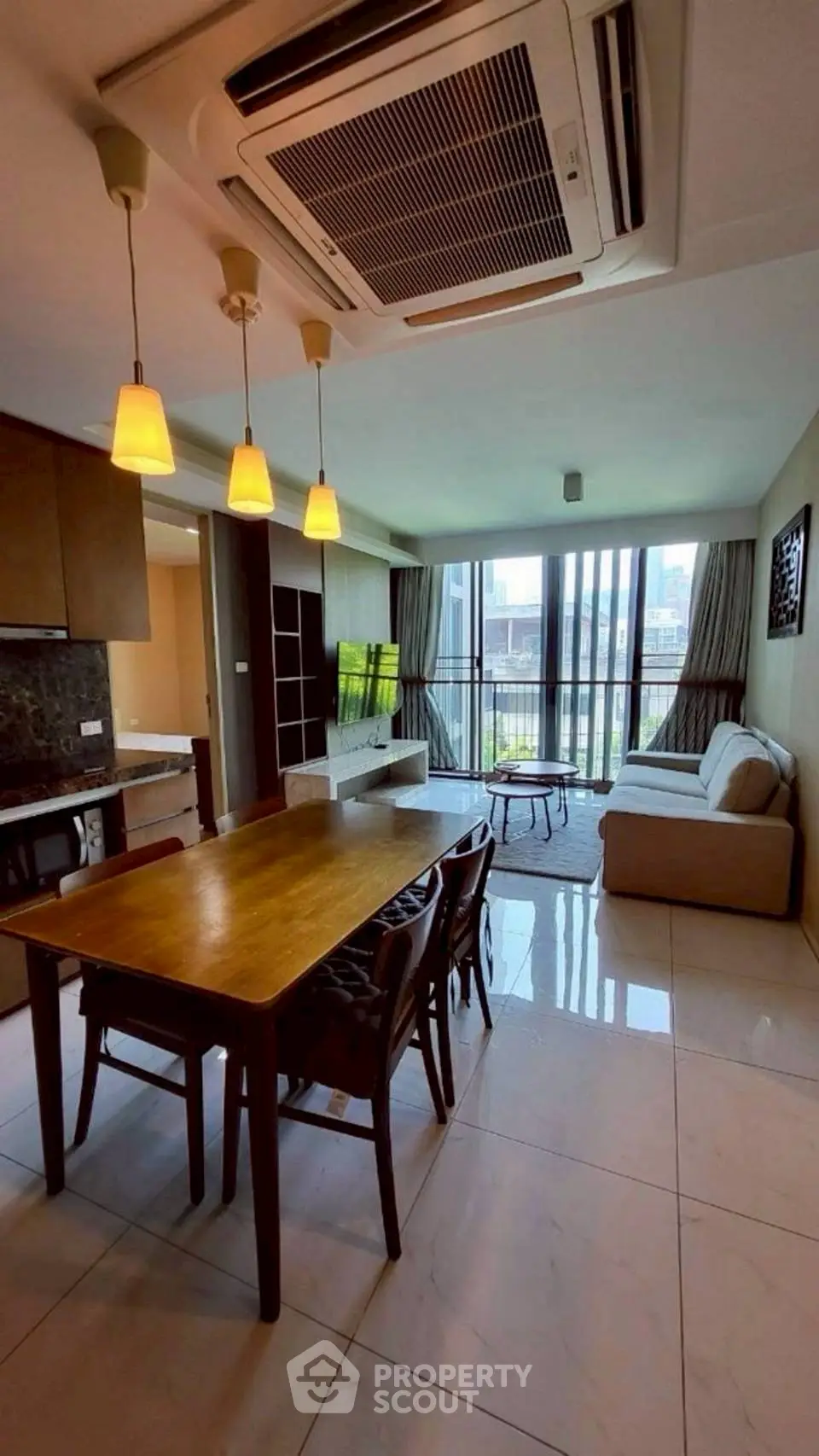 Spacious modern living room with dining area and large windows in a stylish apartment.