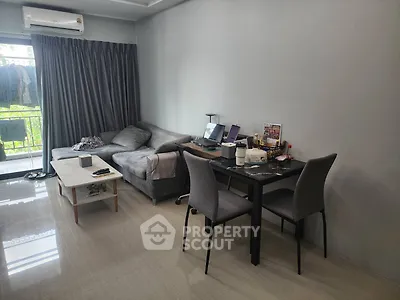 Modern living room with sleek furniture and natural light, perfect for urban living.
